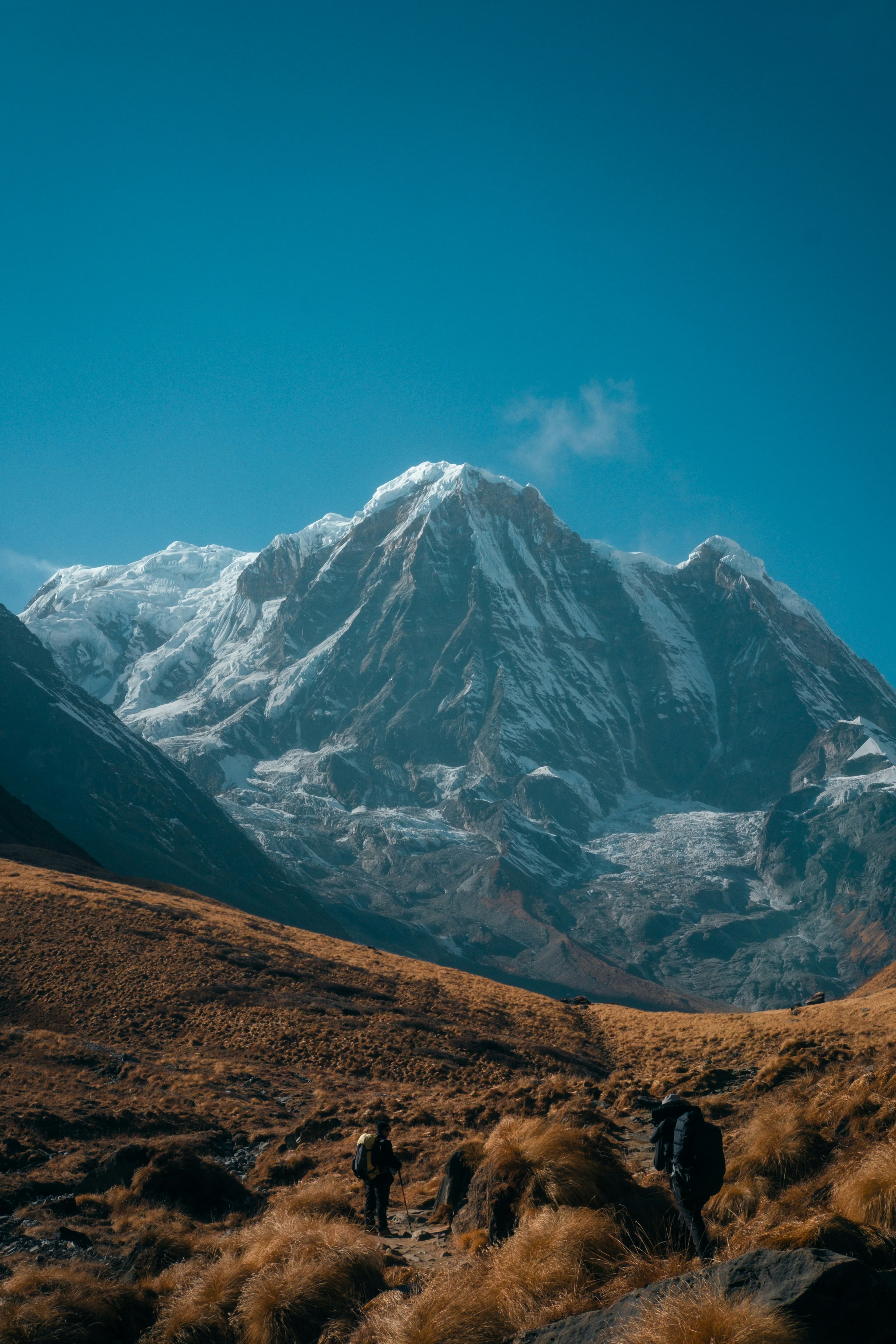 Travellers walking through a high Himalayan valley