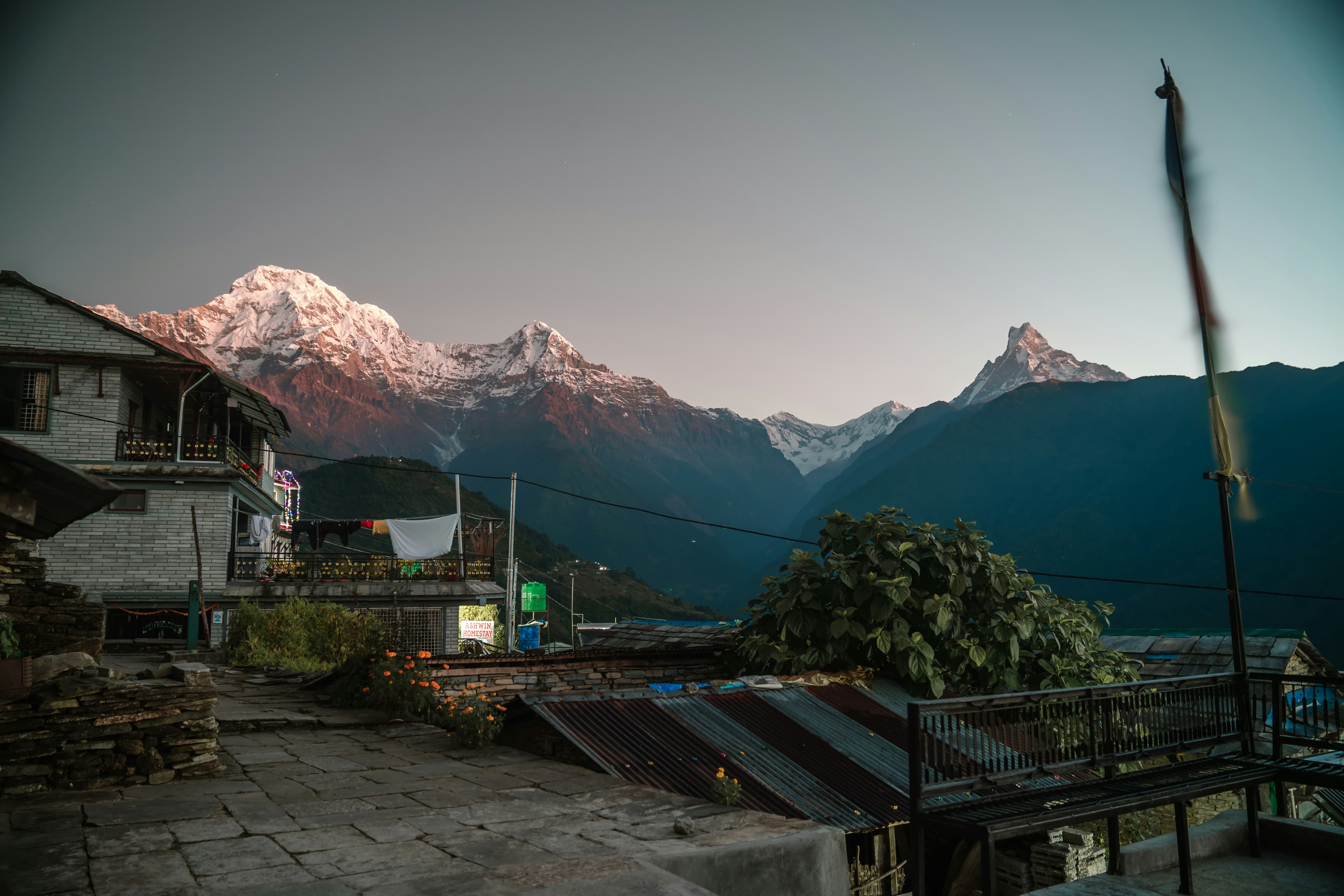 A mountain village beneath snow-capped Himalayan peaks